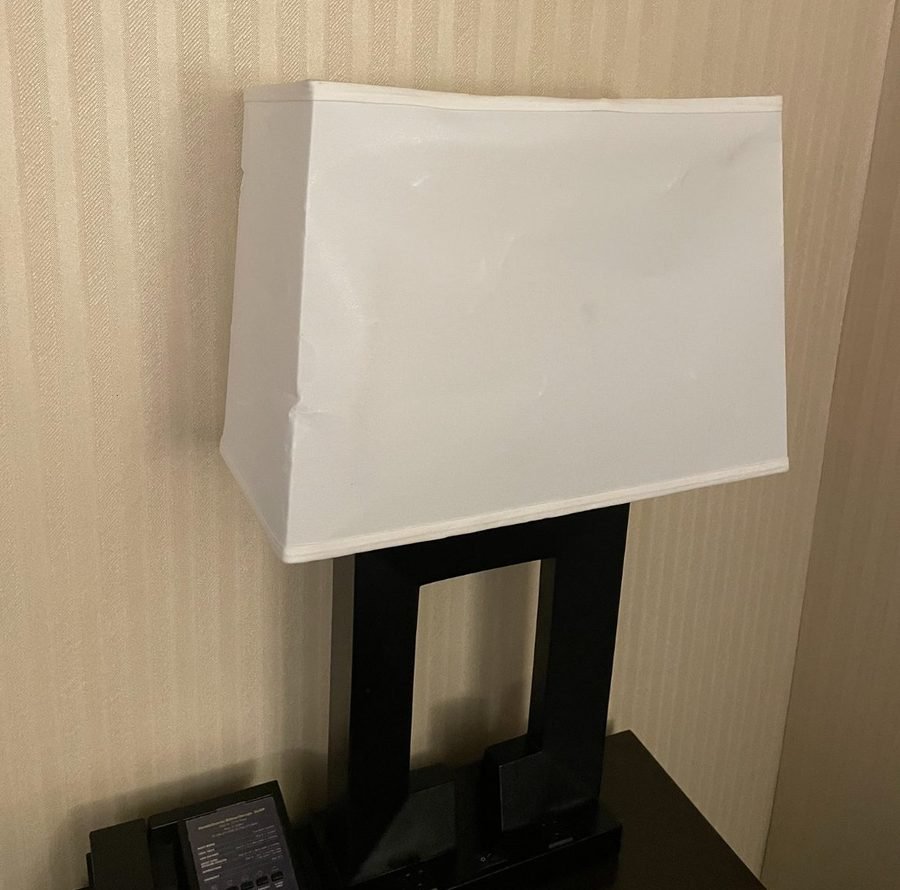 Hotel desk lamp with an old, worn lampshade