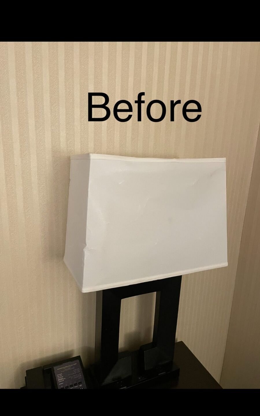 Hotel desk lamp with an old, worn lampshade